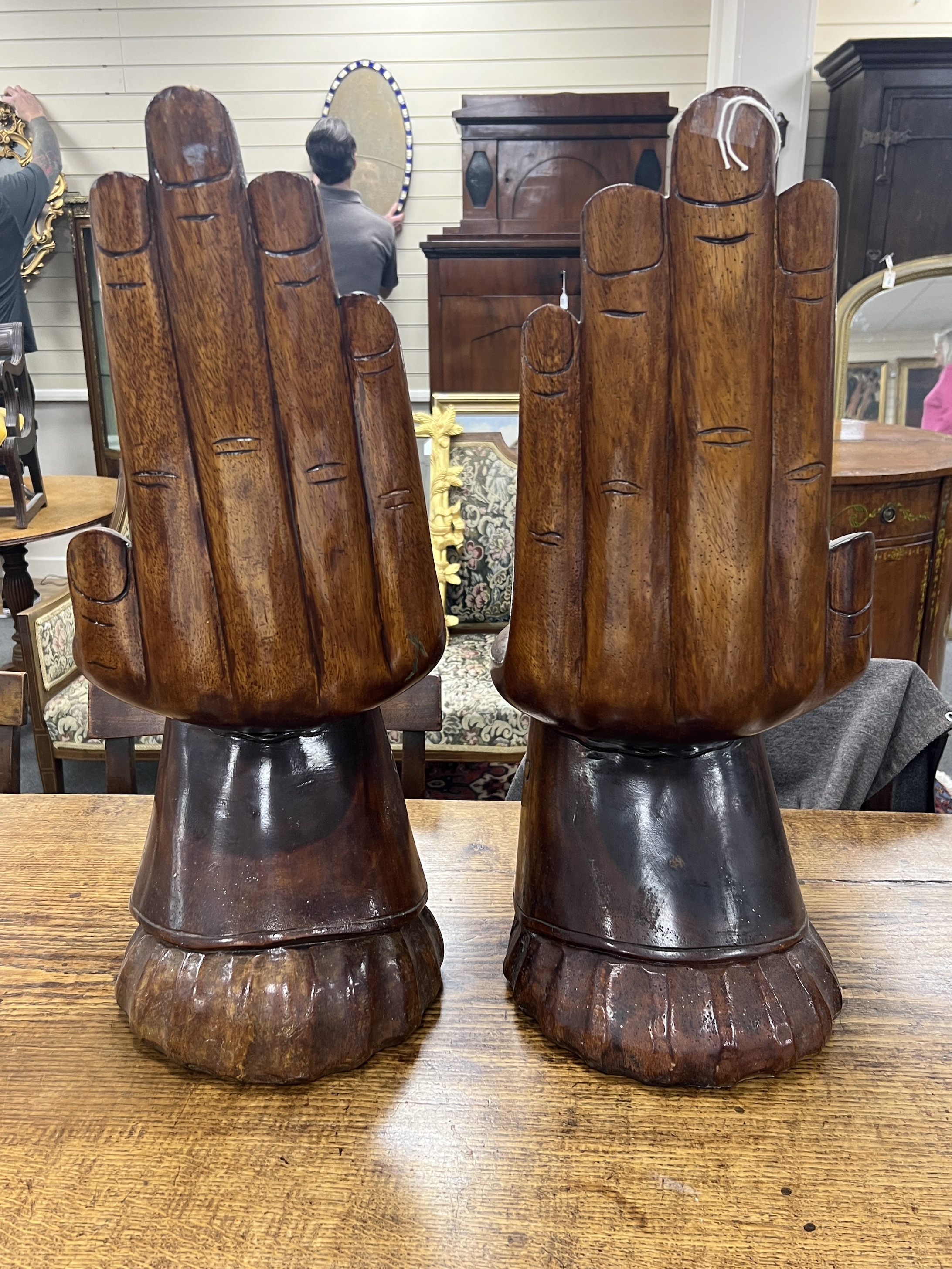 A pair of Eastern carved hardwood stools modelled as hands, height 66cm